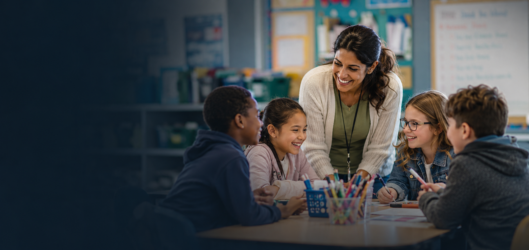 A paraprofessional working with students at a classroom table
